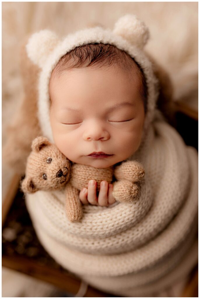 little one holds tiny teddy by Amy Yang Photography