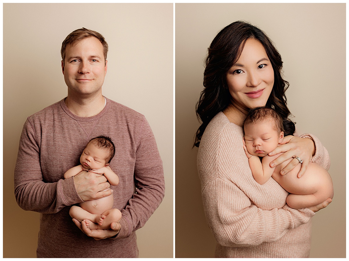 parents hold brand new baby by Charlottesville photographer