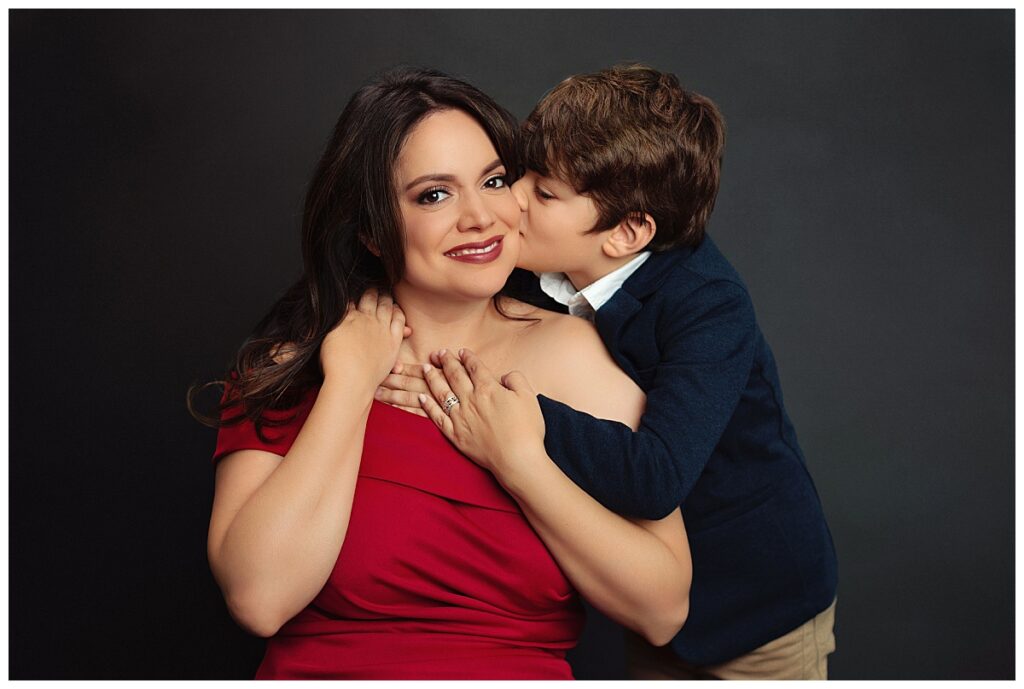 son kisses his mom on the cheek by Amy Yang Photography